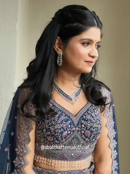 A soft and pretty look for a sangeet night. This client's features are enhanced with subtle contouring, defined eyes, and a half-up hairstyle with gentle waves.