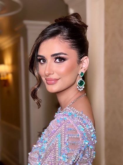 A close-up of the high-glam makeup. The winged eyeliner is sharp, the skin is luminous, and the overall look is one of pure elegance and sophistication.