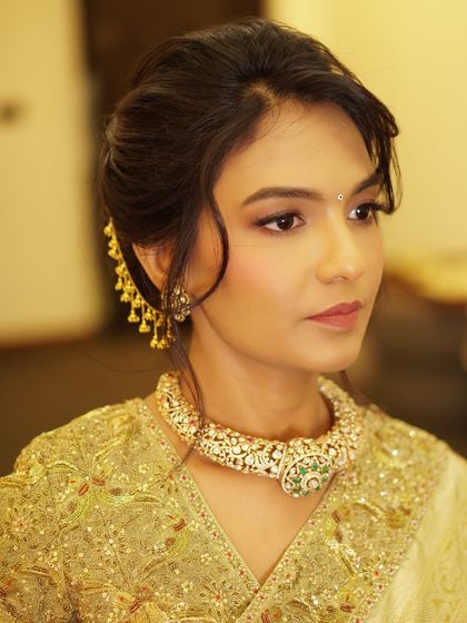 A profile view showcasing the elegant updo and soft makeup for this housewarming. The look is sophisticated and timeless, perfect for hosting a special celebration.