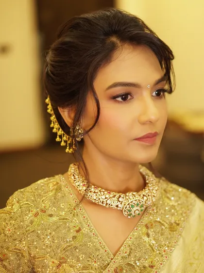 A profile view showcasing the elegant updo and soft makeup for this housewarming. The look is sophisticated and timeless, perfect for hosting a special celebration.