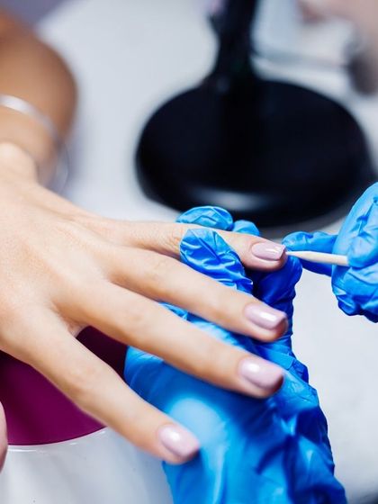 The art of gel application. Our technician carefully applies gel polish, which is then cured under a UV light for a durable, glossy, and long-lasting finish.