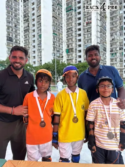Our coaching team with a group of young male champions. We are proud to guide athletes of all ages and genders to success in competitive roller sports.