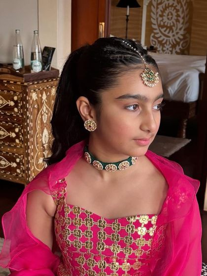 The complete look for a young client, featuring a braided high ponytail and a maang tikka. This is a perfect example of age-appropriate festive hairstyling.