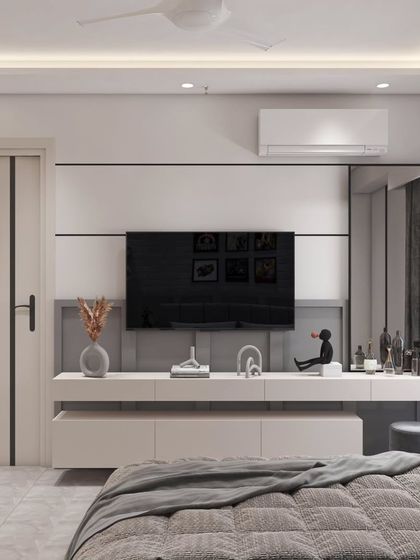 The TV and entertainment unit in the kids' room is designed to be sleek and minimalist. The floating console provides storage while keeping the floor clear, and the simple white and grey palette keeps the look clean.