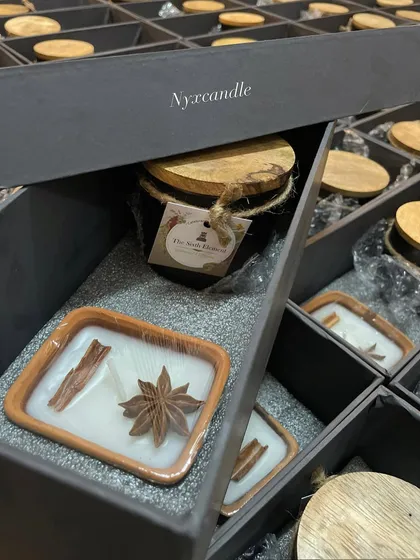 This corporate gift hamper features two of our popular candle types: a spice-topped candle in an earth pot and a lidded black jar candle. The custom-fit insert ensures the products are secure and presented beautifully.