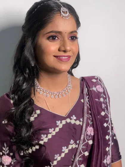 The final Sangeet look for this beautiful bride. The soft makeup with a pop of color on the lips and eyes perfectly complements her diamond jewelry and elegant purple outfit.
