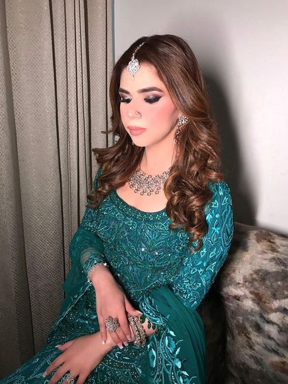 A close-up of the client's soft curls, showing the texture and shine of the hairstyle. This is a glamorous look that is perfect for any evening celebration.