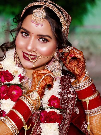 A close-up bridal portrait focusing on the bride's happy expression and detailed jewelry.