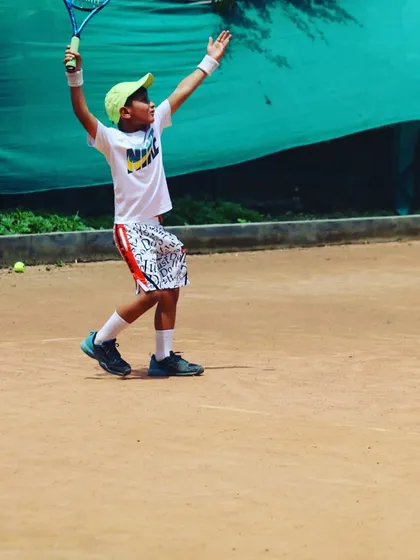 The joy of hitting a great shot! This little champ is celebrating after a powerful forehand.