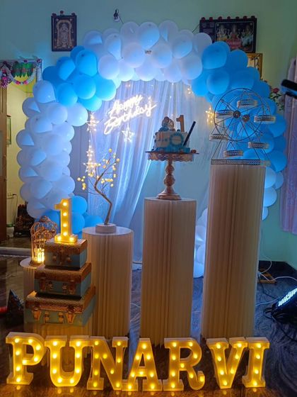 Celebrating a first birthday is always special. For Punarvi's big day, I designed this beautiful blue and white balloon arch with a "Happy Birthday" neon sign, a light-up number '1', and marquee letters spelling her name.