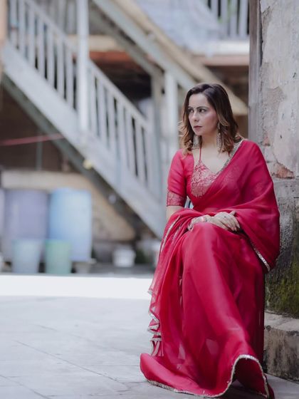 A moment of stillness in the same urban setting. The composition uses the leading lines of the staircase in the background to draw the eye towards her serene profile.