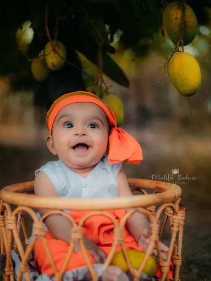 That happy, open-mouthed smile is pure gold. This little boy loved his adventure at the mango farm.
