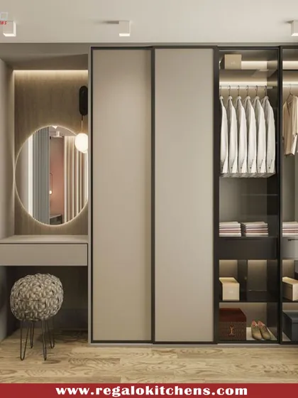 This wardrobe combines sliding doors with an attached vanity. The round mirror and dedicated dressing table create a functional corner that feels both personal and chic.