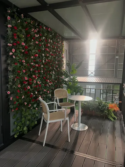A cozy balcony retreat in one of our two-story container homes. The vertical garden wall adds a touch of green, creating a private and serene outdoor space for relaxation.