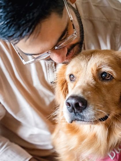 A quiet, intimate moment between a father and his Golden Retriever, Diggy. The soft lighting and close crop emphasize the deep, unspoken connection.