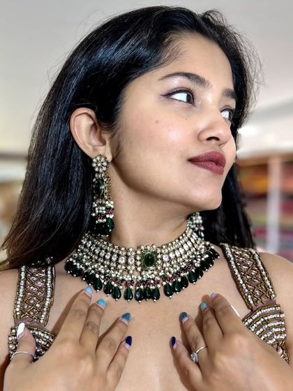A side view highlighting the beautiful earrings and the intricate work on the choker.