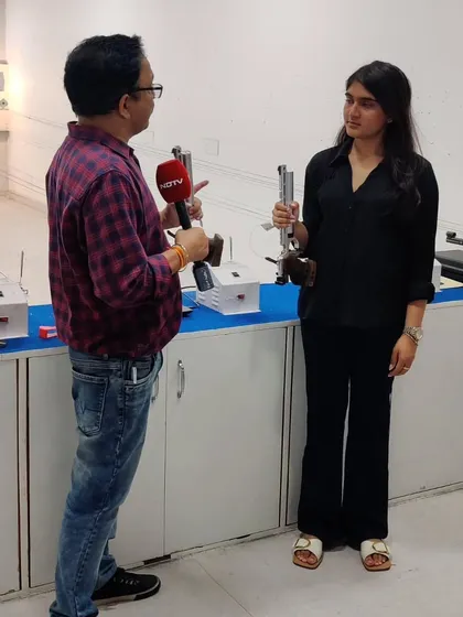 An NDTV reporter interviews Olympic-bound shooter Esha Singh at our facility, discussing her preparations for the games.