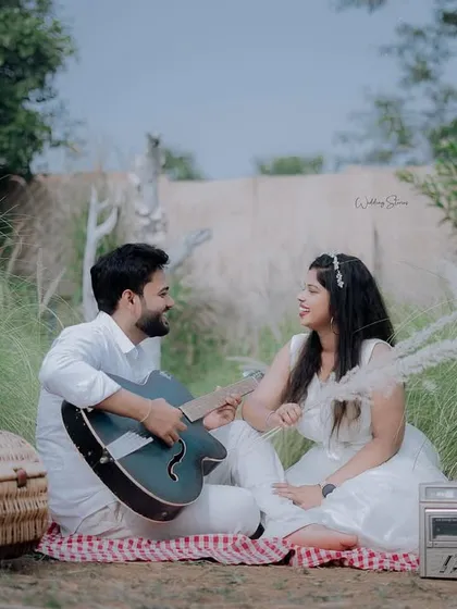 A classic picnic setup is always a romantic choice. Here, the groom-to-be serenades his partner with a guitar, creating a sweet and musical moment.