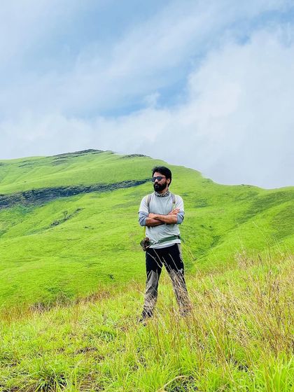 A trekker enjoying the view of the lush green Netravathi hills.