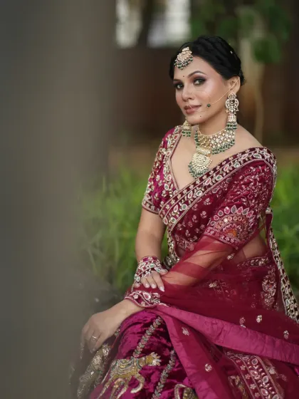 A beautiful candid shot of the bride sitting, her velvet lehenga looking rich and royal.