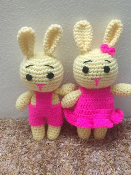 A cute bunny couple. The boy is in pink overalls and the girl is in a pink dress. A perfect gift for Easter or for twins.
