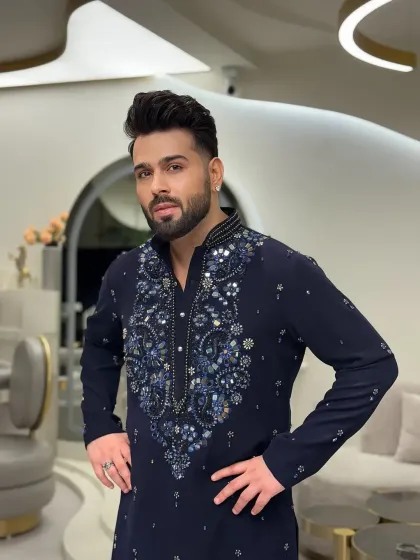 The client striking a pose in the navy blue kurta.