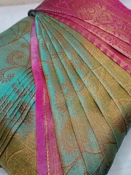 A beautiful teal and pink silk saree, pleated for a flawless drape.