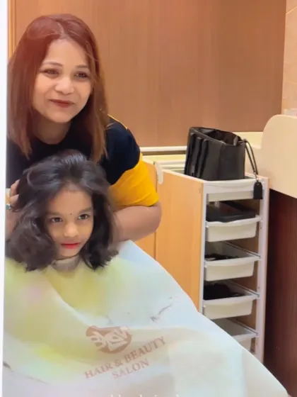 A sweet moment between our stylist and a young client. We treat every child with care and patience.