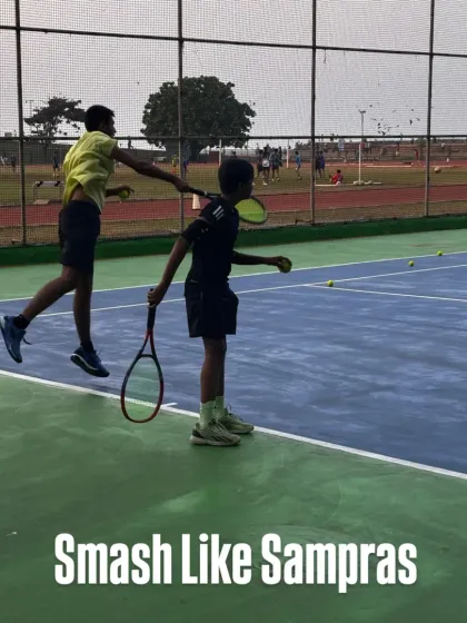 A powerful smash requires timing, technique, and confidence. Here, a coach guides a young player to execute a perfect overhead smash, a crucial skill for any aspiring champion.