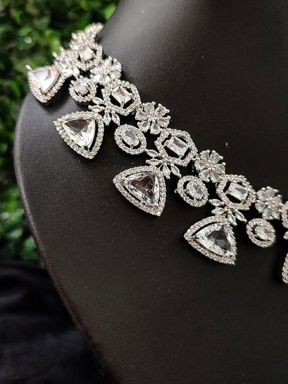 A close-up of the geometric design of this modern American Diamond necklace.