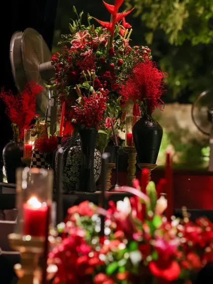 A wider view of the floral arrangements, showcasing the depth and layering of red textures that defined the 'Red Royal Affair' theme.