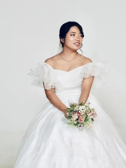 A lovely portrait of a client in our white ball gown. The soft organza fabric and romantic design make it a flattering choice for any bride-to-be.