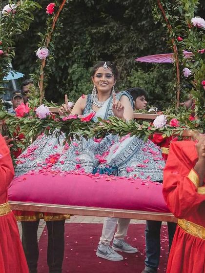 Another angle of the bride's doli entrance. The floral-adorned carriage and the festive music create a truly royal and memorable experience for the bride.