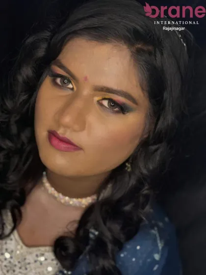 This image showcases a vibrant Haldi makeover, with the hair styled in soft curls to frame the face beautifully. Our students learn to create looks that are both traditional and modern.