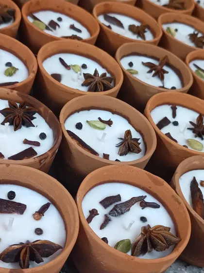 A batch of my spice-scented terracotta candles ready for a client. Each one is hand-poured and decorated with a mix of whole spices, including star anise, cardamom, and black pepper.