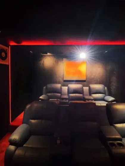 Entertainment spaces should be immersive. I designed this private home theater with plush recliner seating, dramatic red and black accents, and professional-grade acoustics to create a true cinematic experience right at home.