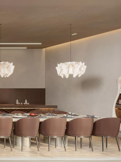 A glimpse of the dining area at Siori Lilly Villas. The space is defined by soft, organic forms, from the sculptural mirror to the paper-like pendant lights, creating a gentle and inviting atmosphere for meals.