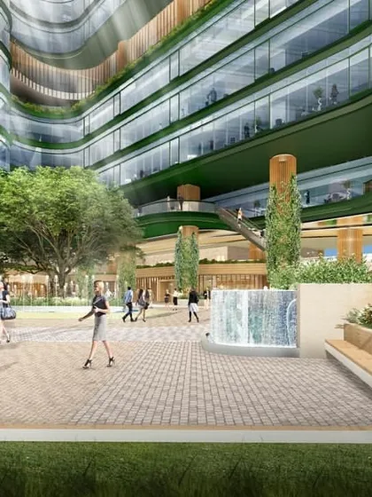 An interior courtyard rendering for the NESCO Centre, showing a vibrant public square with fountains and seating areas. This space is designed to be the social heart of the campus, promoting interaction and community.
