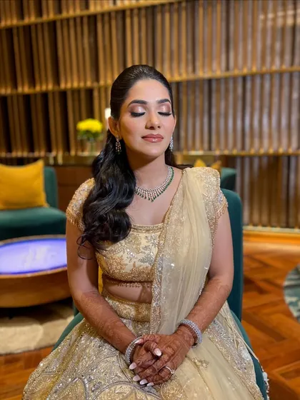 This shot highlights the beautiful shimmer on the eyelids, adding a touch of glamour to Supriya's sophisticated Sangeet look.