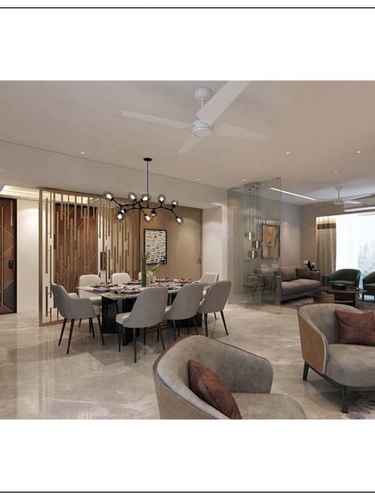 An example of modern eclectic design in a Mumbai apartment. The space cohesively blends different textures, a muted color palette, and distinct furniture pieces to create a living area that is warm, inviting, and full of character.