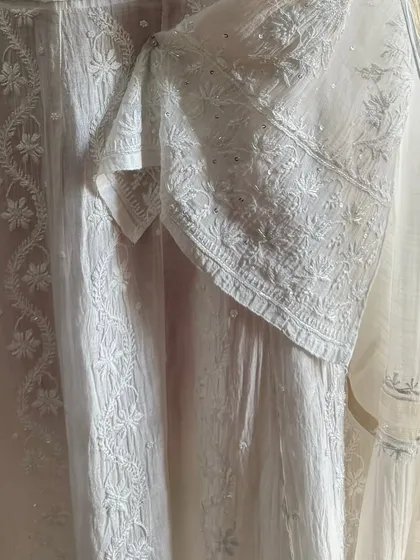 A detail shot of the sleeve and side panel, highlighting the fine craftsmanship of the Chikankari embroidery.