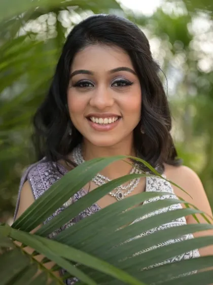 A fresh and youthful engagement look. The bride's lavender lehenga is paired with shimmery eye makeup and a bright, happy smile.
