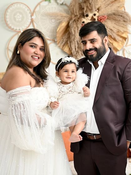 A beautiful family portrait in a dreamy boho setting. The parents' loving gaze towards their daughter makes this an incredibly warm and emotional photograph.