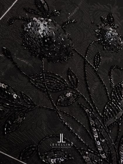 The intricate, hand-beaded embroidery on a black jacquard fabric. This is a sneak peek at the level of detail we can incorporate into our ceremonial pieces.