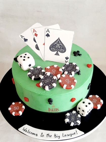 A poker-themed cake for a casino night or a card lover's birthday. This minimal-fondant cake is decorated with playing cards, dice, and poker chips. The flavor was chocolate and raspberry.