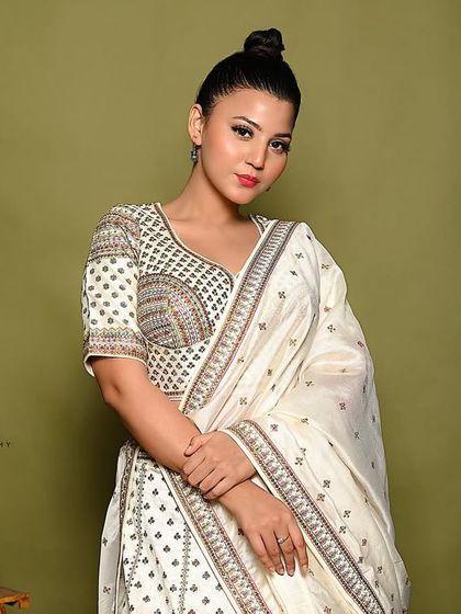 A classic and elegant pose, perfect for showcasing the entire ethnic ensemble.