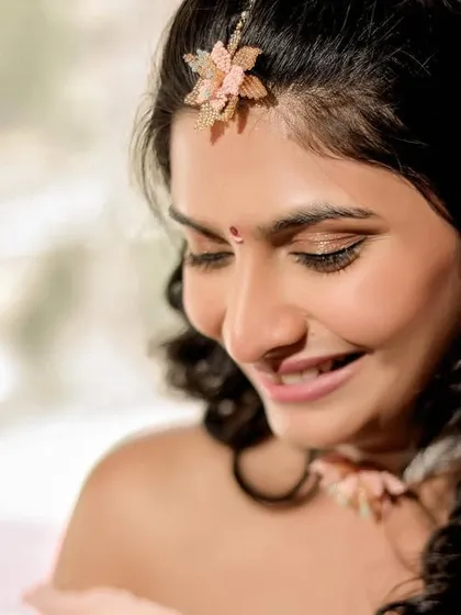 A close-up of the bride's delicate floral jewelry and her happy expression during her destination wedding. These small details add a personal touch to the wedding album.