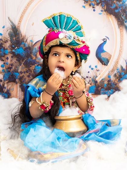 A beautiful girl dressed as Krishna, surrounded by clouds and peacock feathers. I offer a variety of costumes and setups for both boys and girls for this theme.