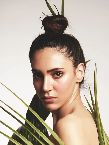 A close-up portrait from the leaf dress series, highlighting the fresh, glowing skin and the simple, elegant hair styling.