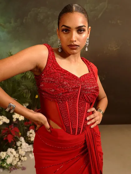 A close-up of the red Stardust Saree Set's corset blouse, where every bead is hand-placed to create a look of pure opulence.